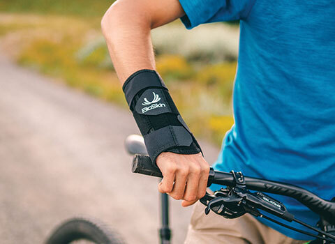 Close-up of a cyclist wearing a BioSkin wrist brace