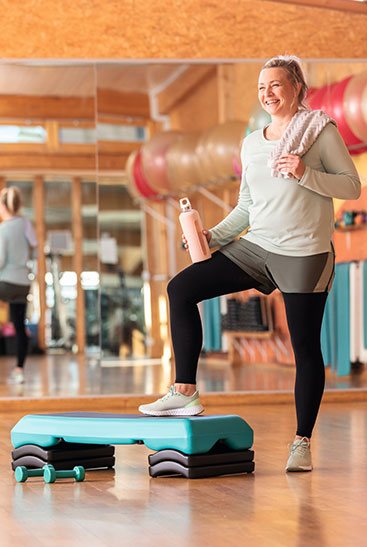 Woman at the gym wearing black Juzo compression stockings