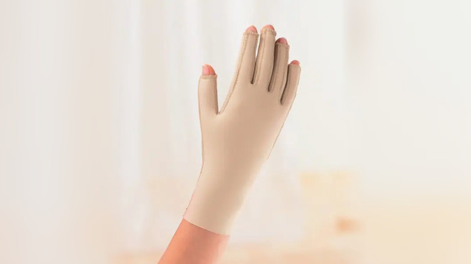 Beige circaid compression glove on a raised hand