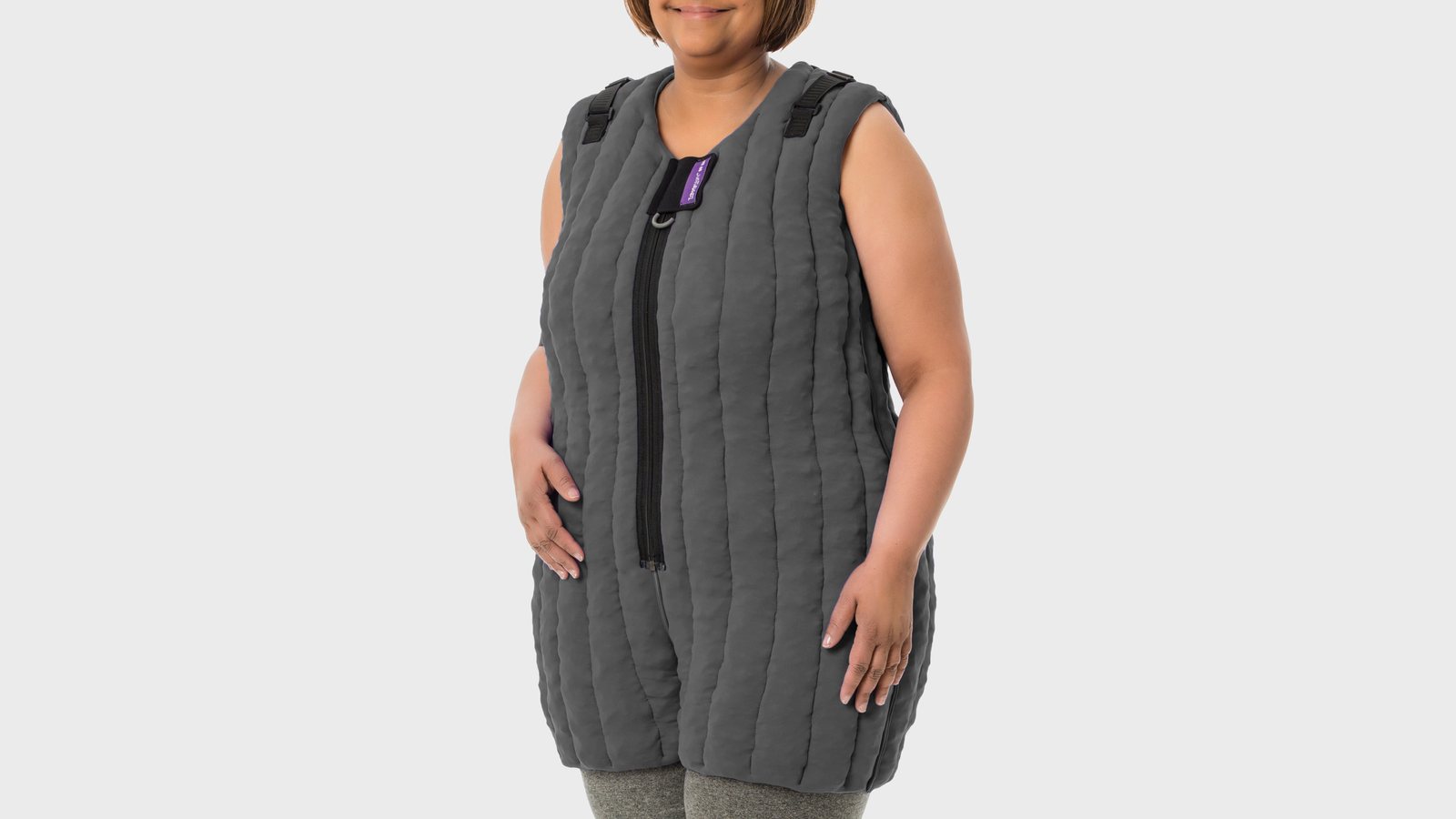 Woman wearing a grey quilted L&R Tribute Night compression vest