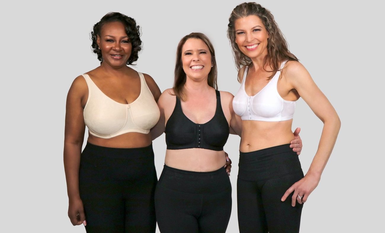 Three smiling women wearing Rose Contour mastectomy bras in beige, black and white